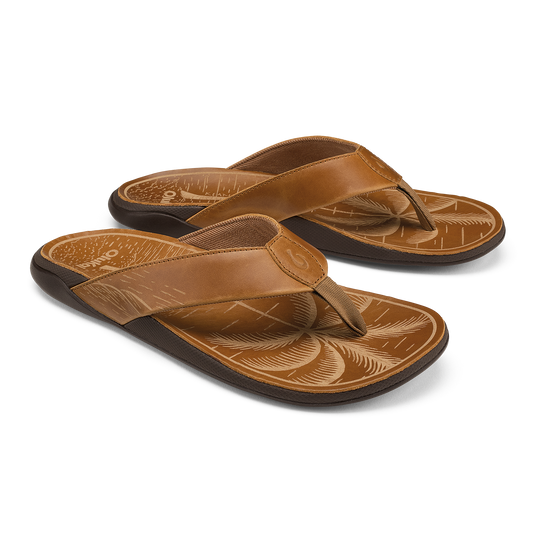 Pair of tan leather flip-flops with black soles and decorative carved footbeds featuring fox designs.