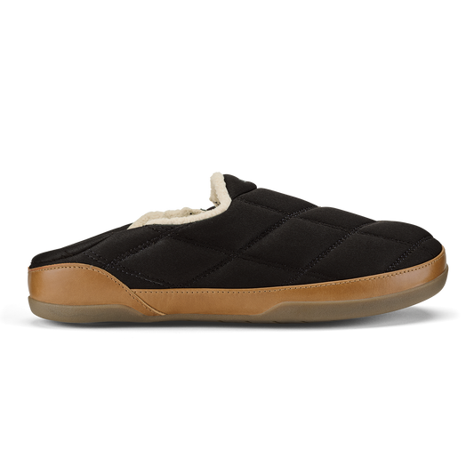 Black quilted slipper with tan leather toe cap and cream fleece lining, shown in profile.