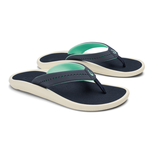 Pair of navy and mint green flip-flops with cream-colored soles and beaded thong straps.