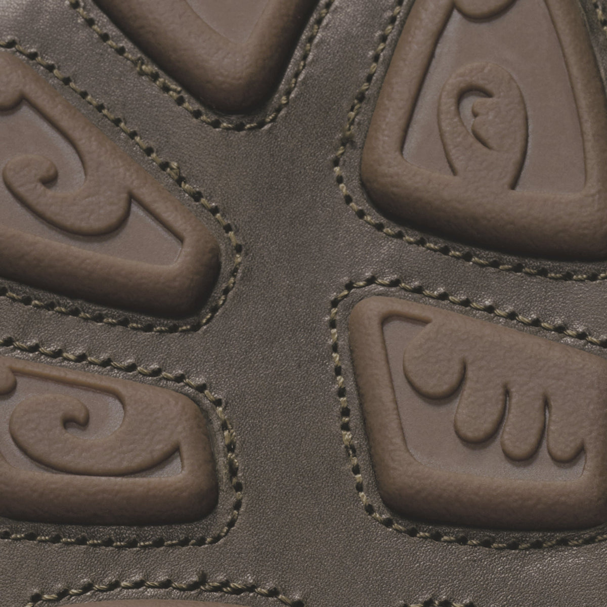 Clay-colored leather upper with embossed curved design panels and contrasting tan topstitching detail.