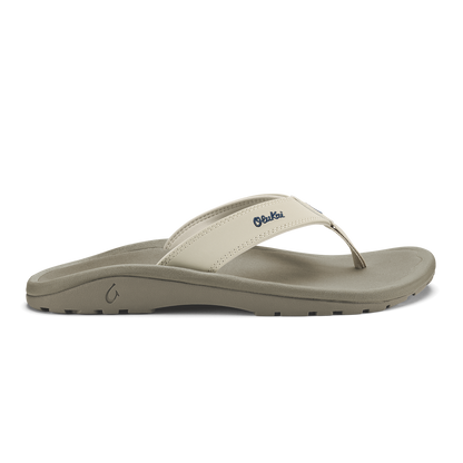 Cream and gray thong sandal with embroidered logo on upper strap and textured sole.