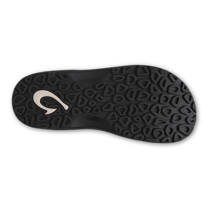 Black shoe sole with geometric tread pattern and white curved logo detail.