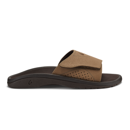 Tan and dark brown slide sandal with perforated upper and dark sole, shown from the side.