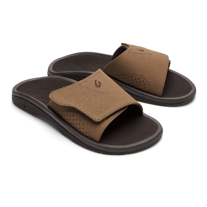Tan leather slide sandals with dark brown soles and perforated toe box detail.