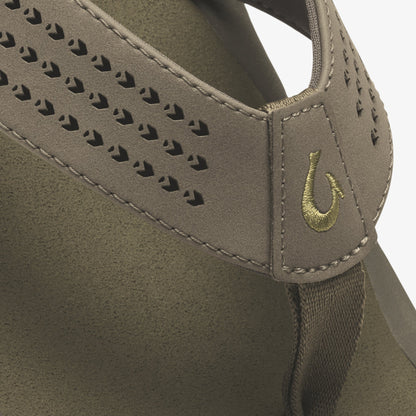 Tan suede hobo bag with perforated detailing and embroidered horseshoe logo on shoulder strap.
