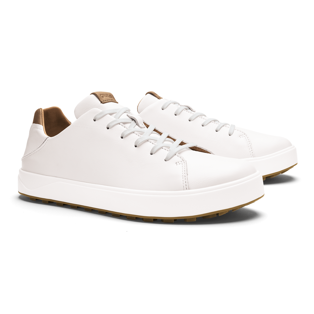 White leather sneakers with tan heel and collar trim, white laces, and tan rubber sole.