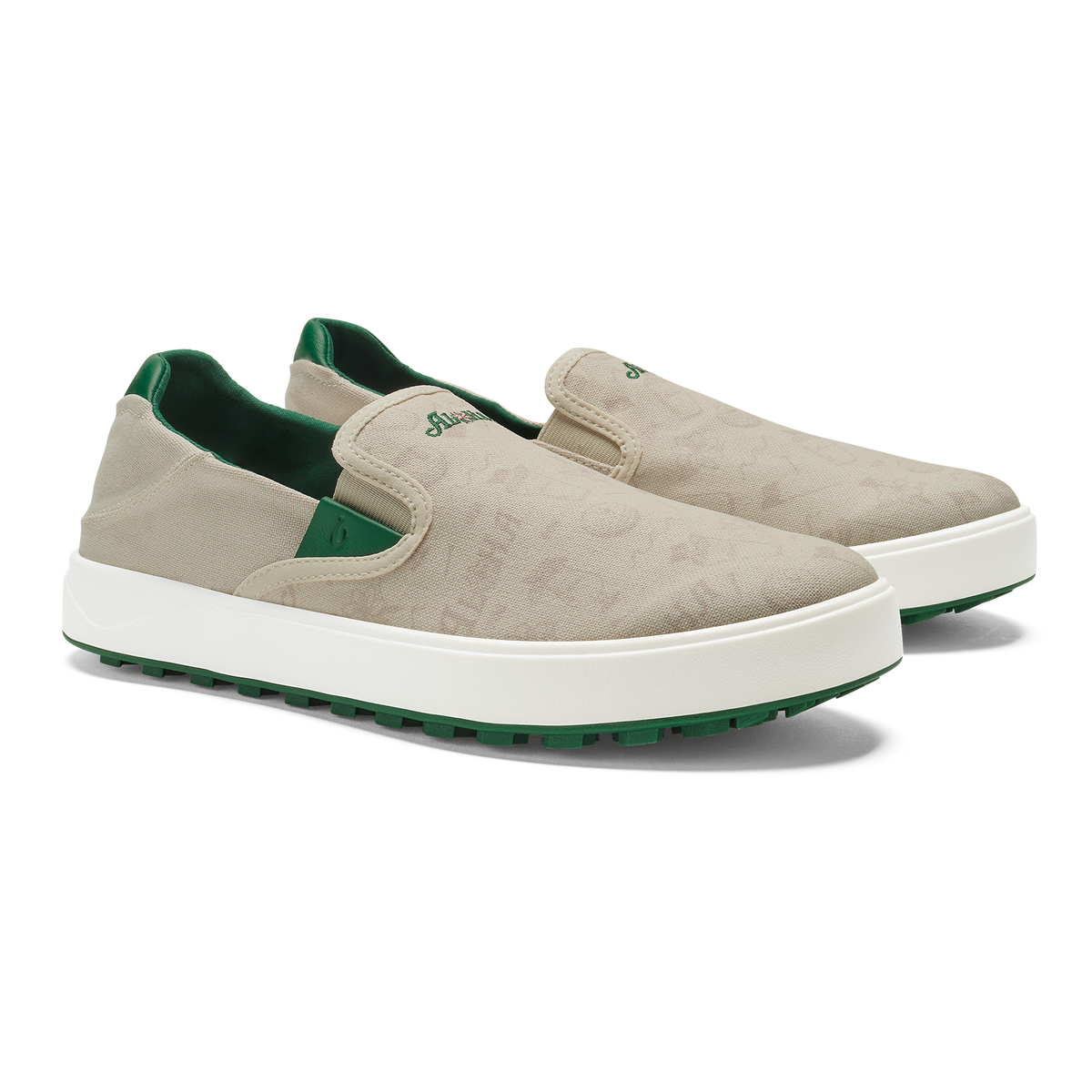 Beige canvas slip-on sneakers with white sole, green heel lining and green rubber outsole.
