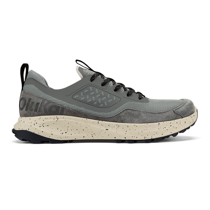Grey and cream athletic shoe with black laces and speckled sole midsole shown in side profile.
