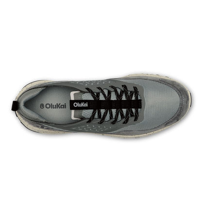 OluKai Makiki athletic shoe in cloud grey with black laces, shown from top view.