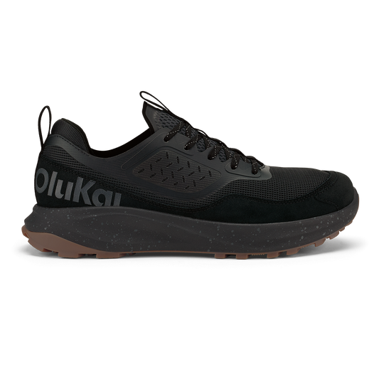 Black lace-up trail running shoe with mesh and suede upper, speckled midsole, and tan rubber outsole.