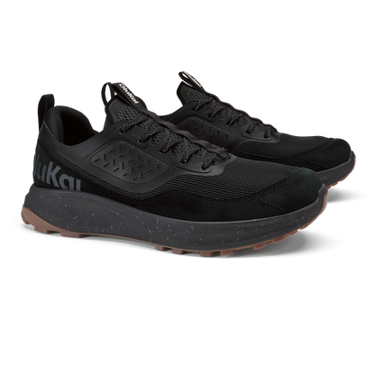 Black lace-up athletic shoe with mesh upper, cushioned midsole, and speckled sole detail.