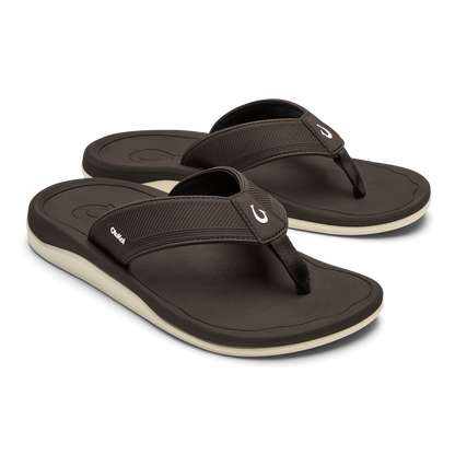 Pair of dark brown flip-flops with ribbed black straps and cream-colored soles.