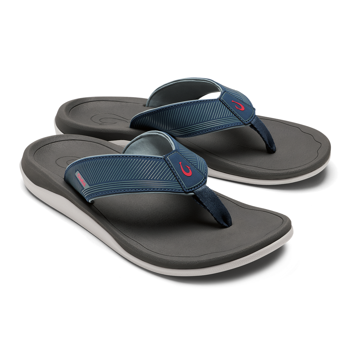 Pair of dark gray and blue thong sandals with white midsoles and striped fabric straps.