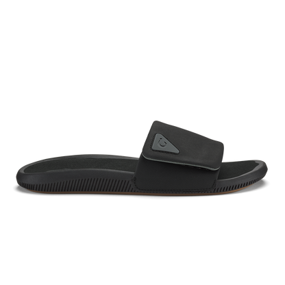 Black slide sandal with textured sole and adjustable padded strap across the foot.