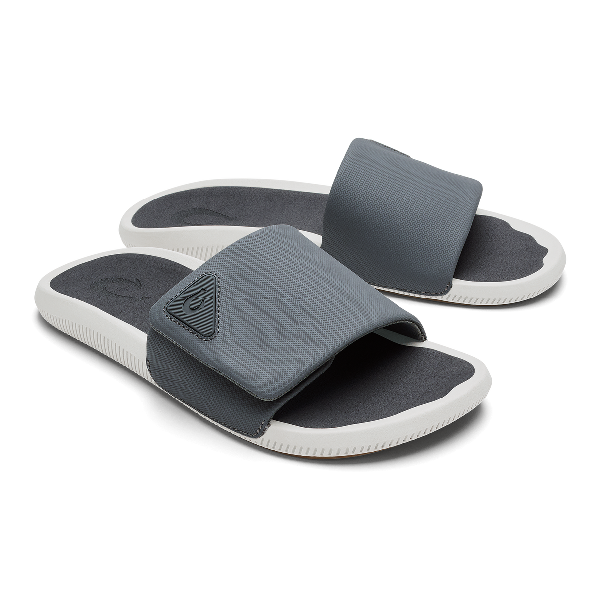 Gray and white slide sandals with dark gray textured straps and dark insoles.