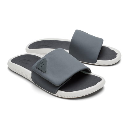 Gray and white slide sandals with dark gray textured straps and dark insoles.