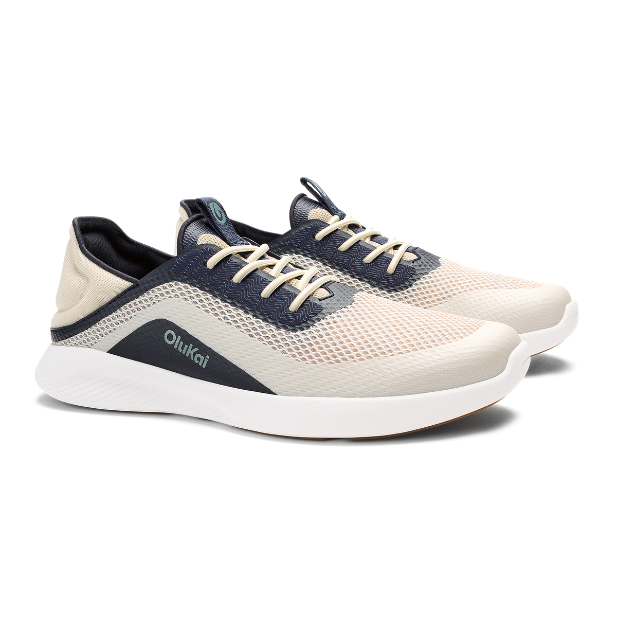 Cream and navy mesh athletic shoe with white sole and tan laces, shown from side angle.