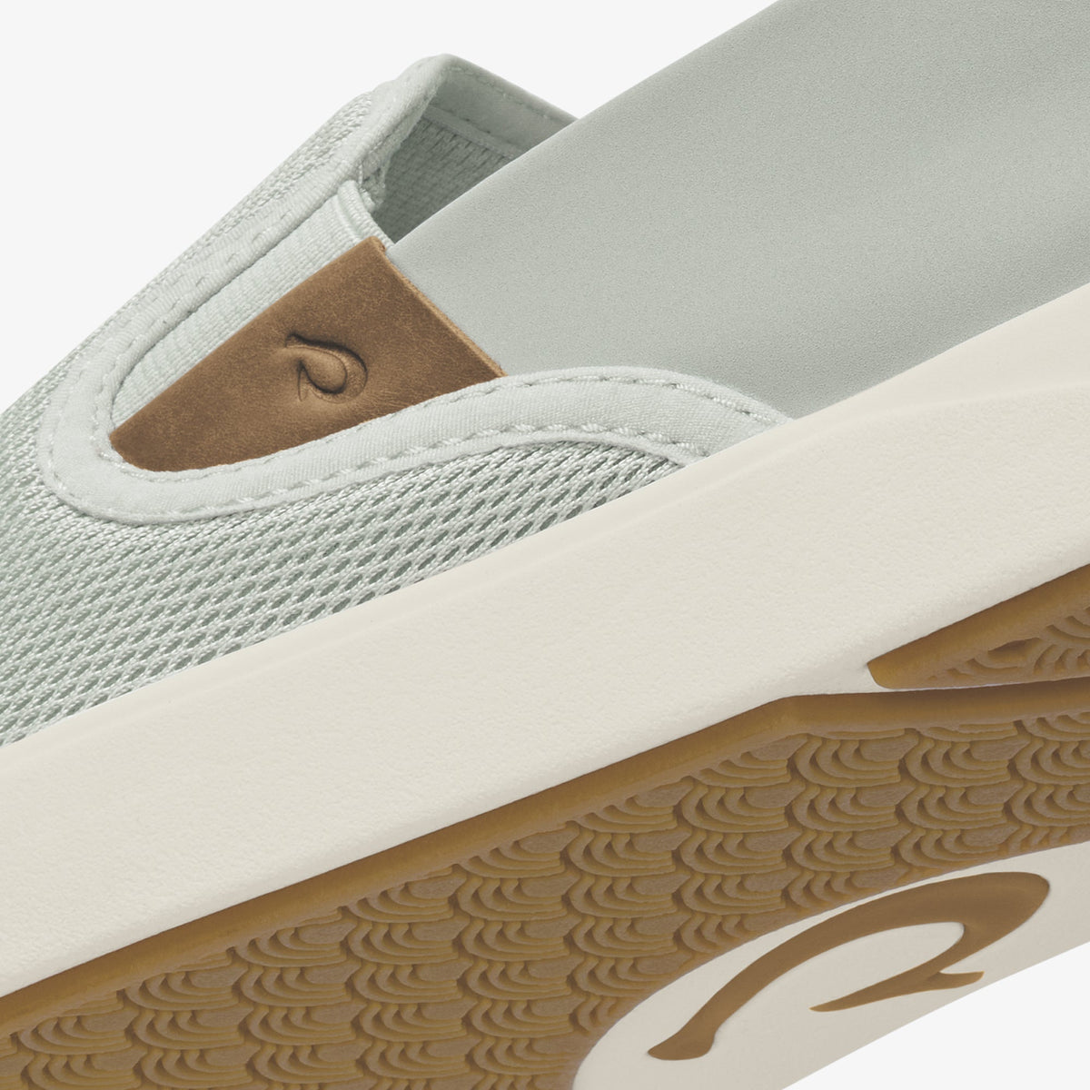Grey and tan slip-on sneaker with textured knit upper, white trim, and gum rubber sole with wave pattern.