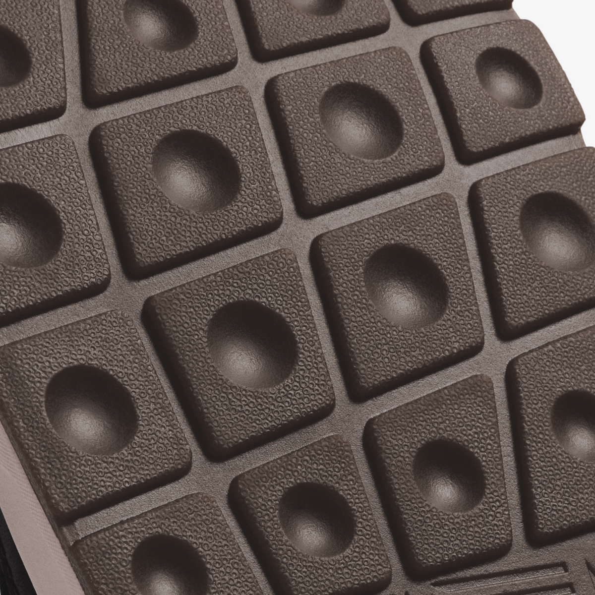 Black textured sole with grid pattern of rounded dome studs.