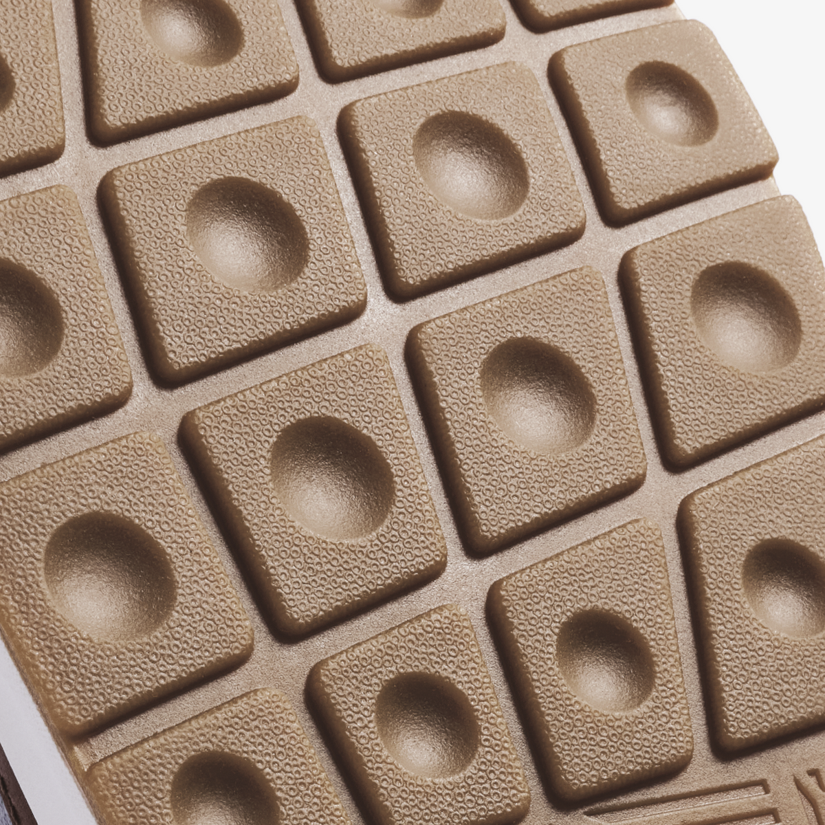 Light grey rubber sole with textured surface and circular dome pattern throughout.