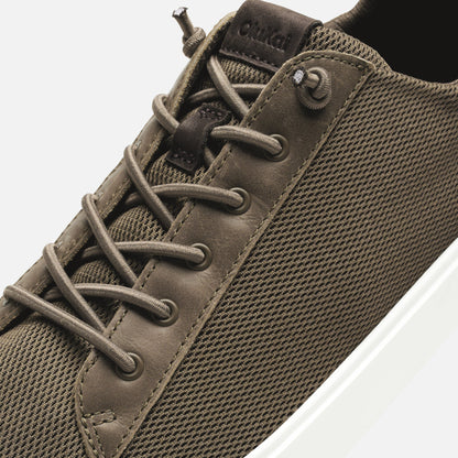 Walnut-colored sneaker with laced closure, textured mesh upper, suede trim, and white sole.