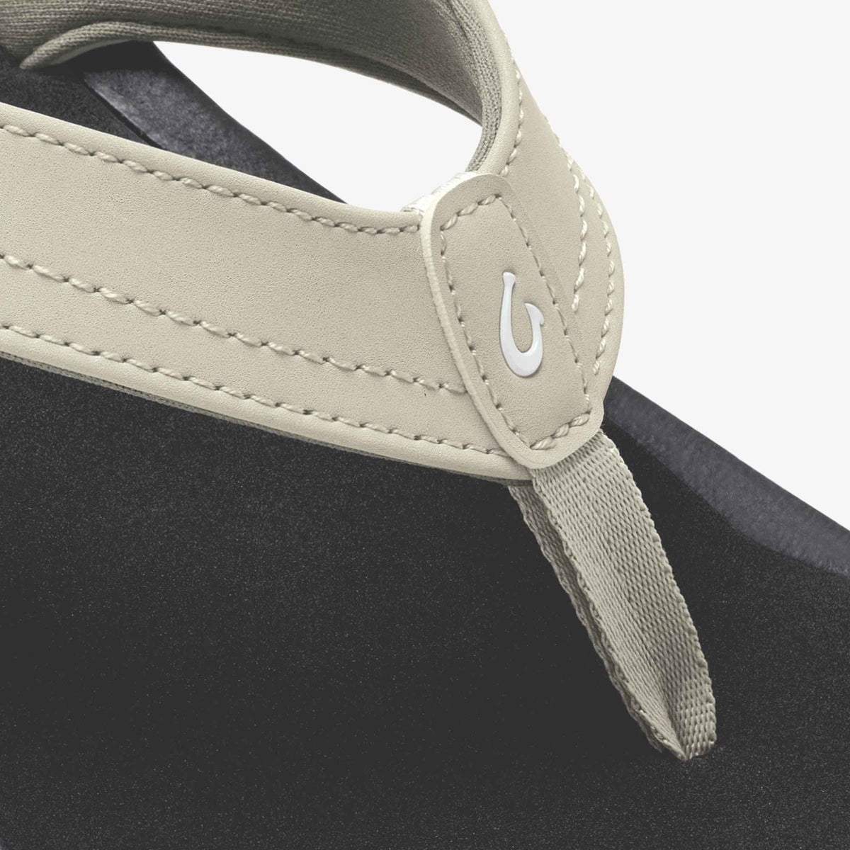 Ecru and black tote bag with woven handles and contrast stitching detail.