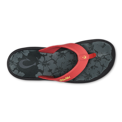 Red flip-flop with black floral-patterned footbed and gold script branding on the strap.