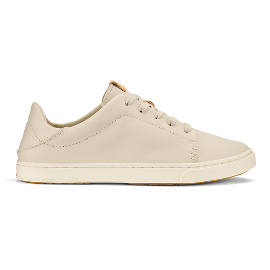Cream-colored leather lace-up sneaker with tan heel accent and stitched details, shown in profile view.