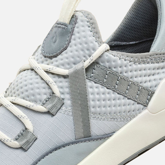 Cloud grey slip-on shoe with white textile straps, grey elastic bands, and cream-colored heel tab.