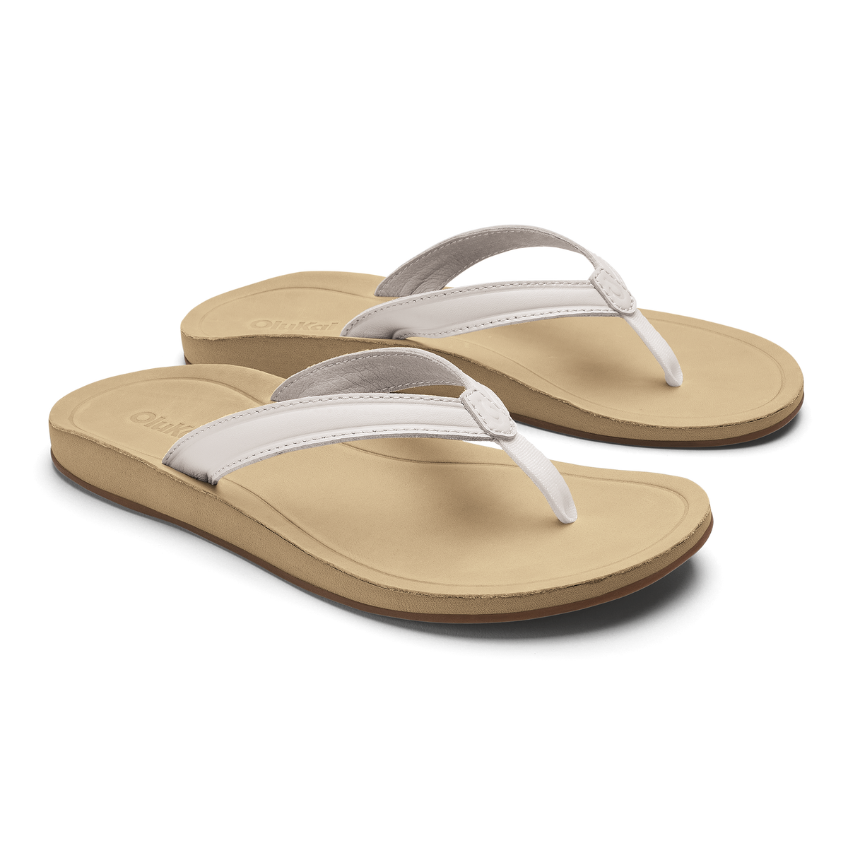Pair of tan flip-flops with bright white straps and gray trim on cushioned soles.