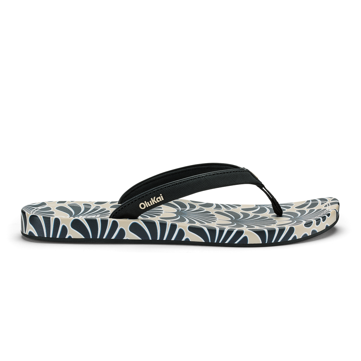 Black and cream flip-flop with geometric fan pattern on sole and black fabric thong strap.