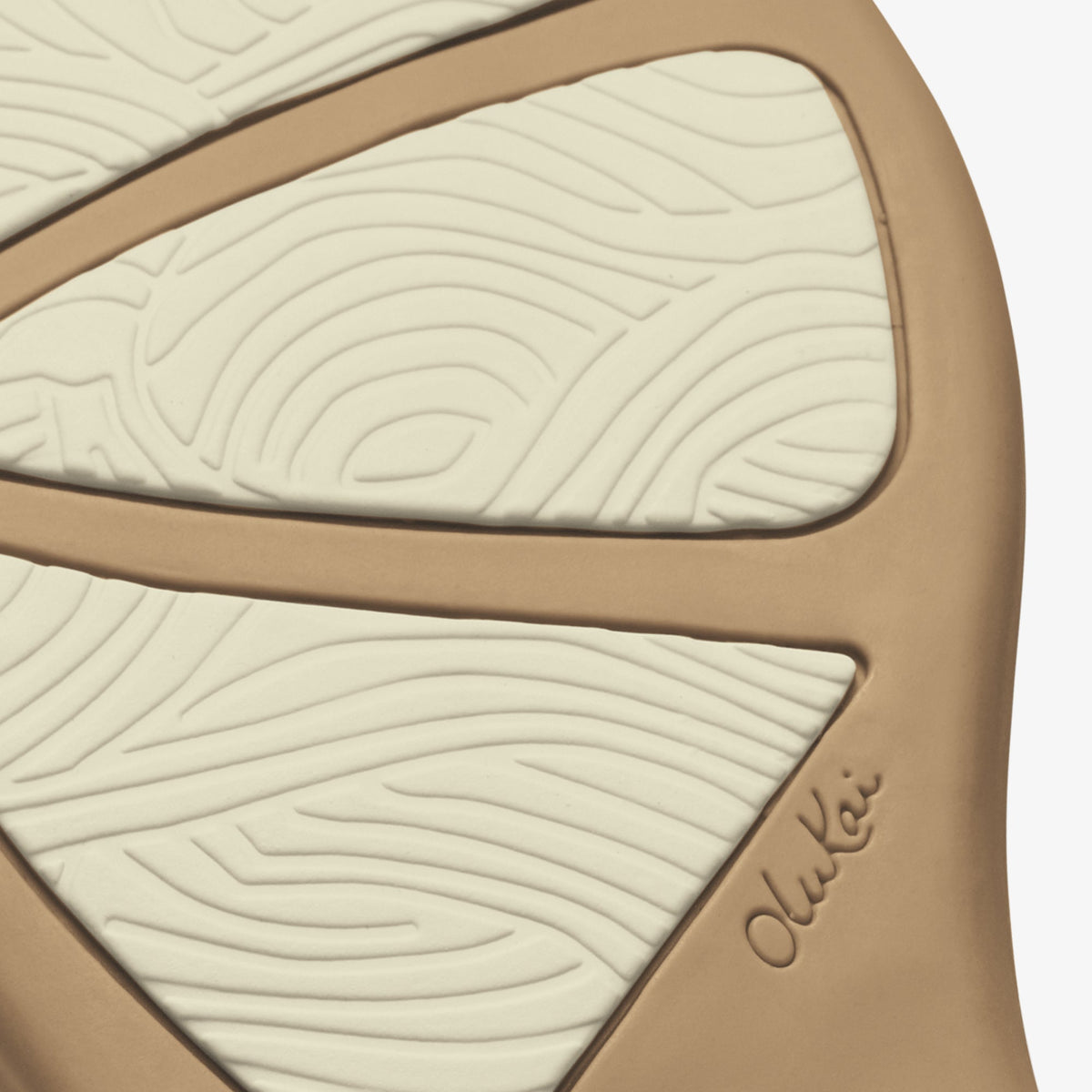 Warm sand-colored sole with bright white textured panels separated by tan trim, featuring wavy linear patterns and embossed b