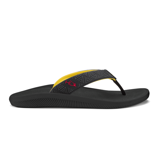 Black flip-flop sandal with yellow and patterned black thong strap and textured sole.