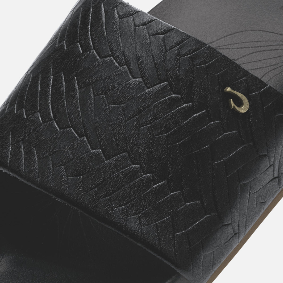 Black woven bag with quilted diamond pattern and gold-tone hook closure detail.