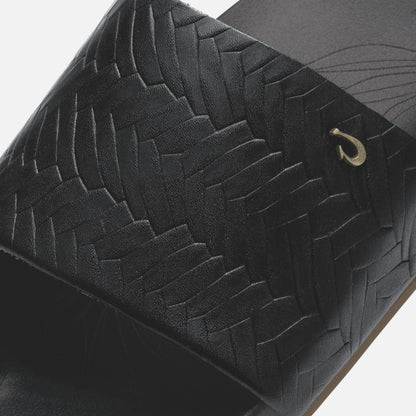 Black woven bag with quilted diamond pattern and gold-tone hook closure detail.