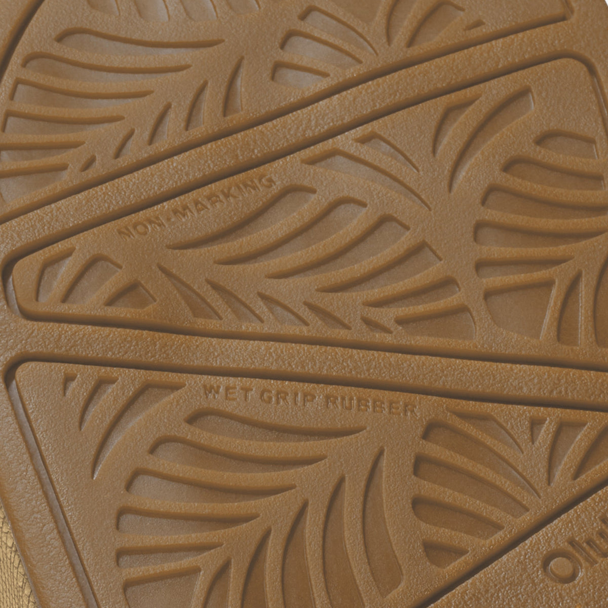 Tan rubber sole with embossed leaf pattern and diagonal crosshatch texture.