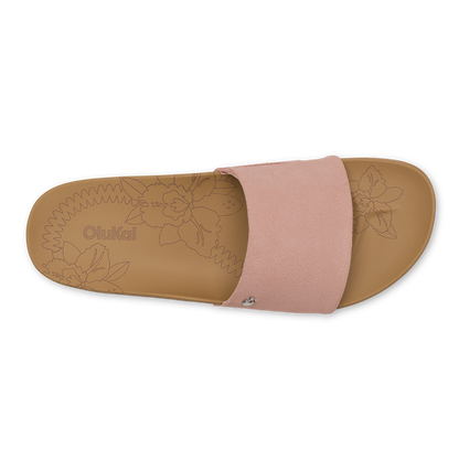 Slide sandal with warm sand-colored footbed featuring floral design and soft pink fabric upper band.