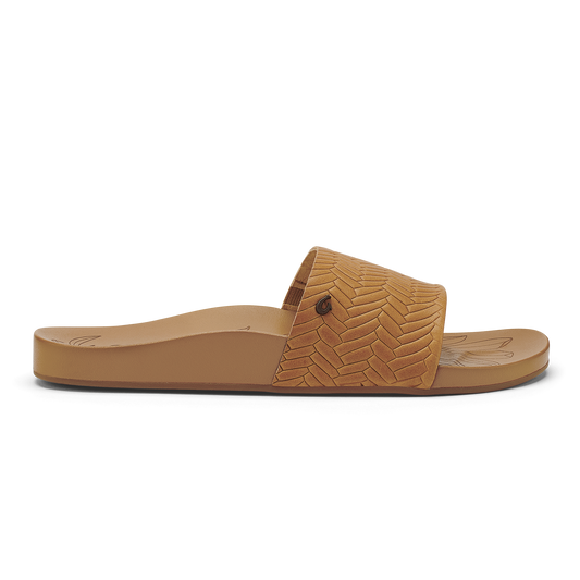 Tan slide sandal with woven herringbone pattern upper and flat sole.
