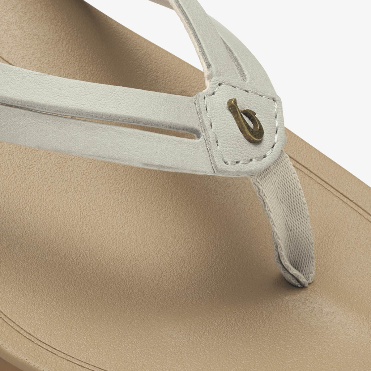 Beige tapa bag with light gray handles and metal grommet detail on shoulder strap.