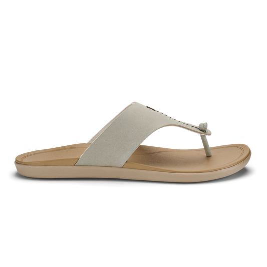 Cream and tan thong sandal with padded fabric upper and cushioned sole.