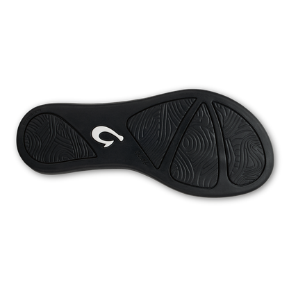 Black sole of Ho'ōpio Mele sandal with white logo and textured tread pattern.