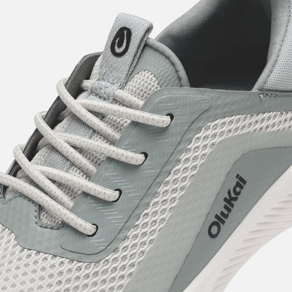 Gray and white athletic shoe with white laces, mesh panels, and Oiikai branding on the side.