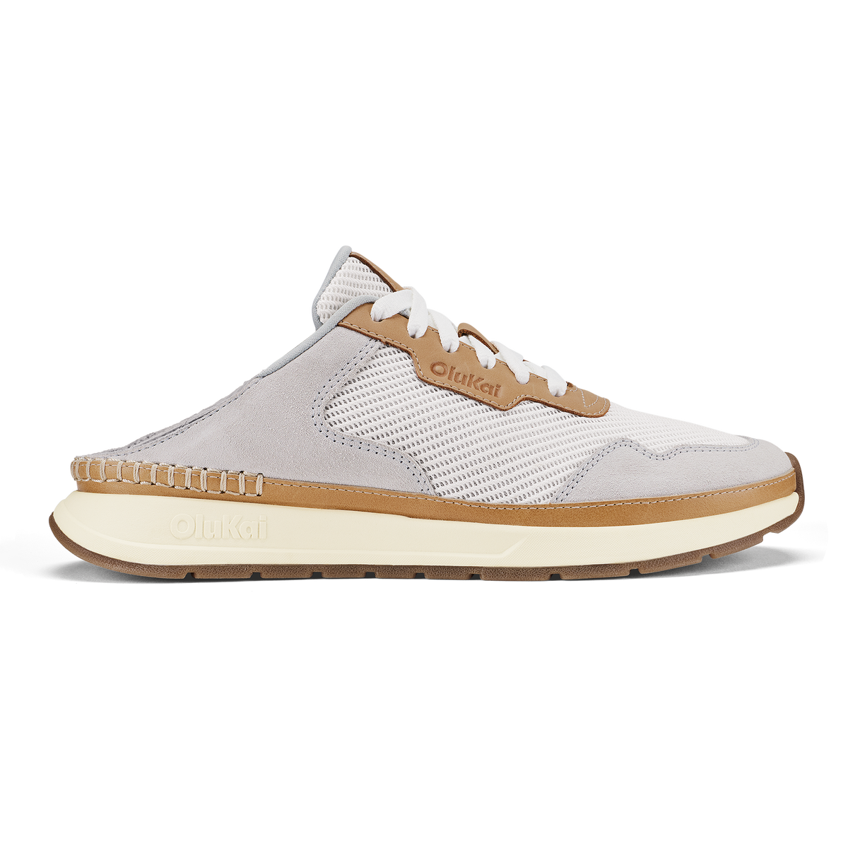 White and tan slip-on sneaker with mesh paneling, white laces, and cream-colored sole.