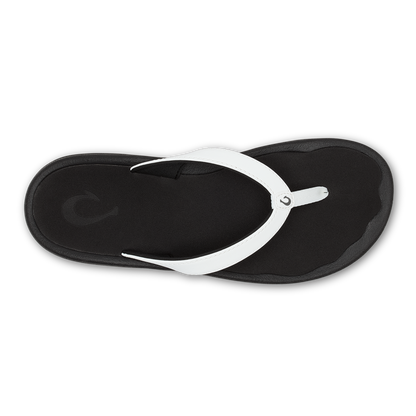 Black flip-flop with white thong strap, viewed from above.