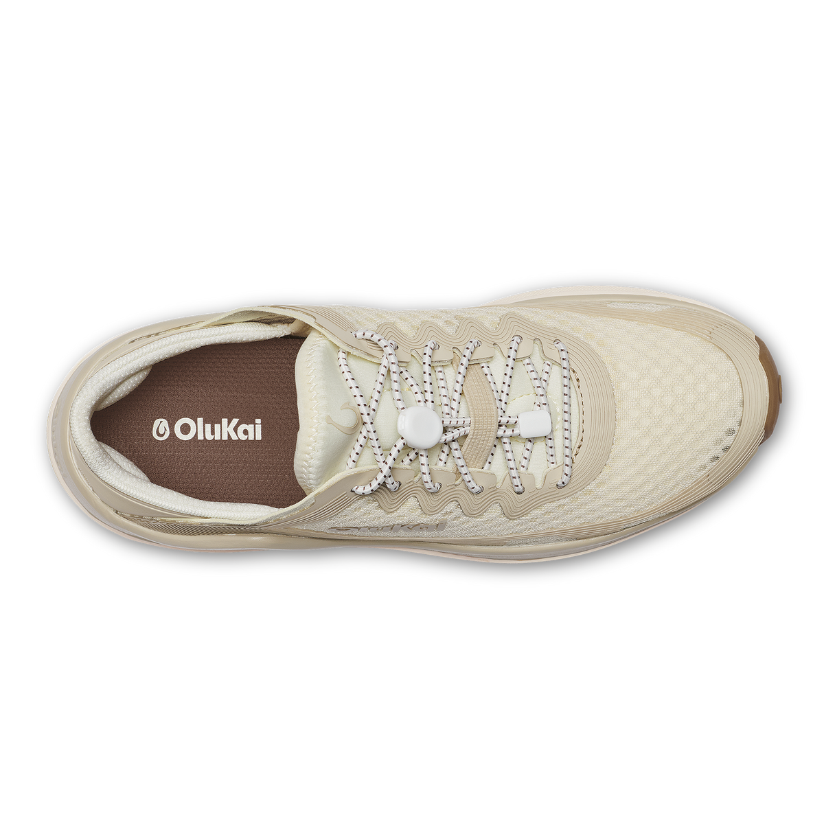 OluKai Ahi sneaker in white sand with reflective laces and brown interior lining, shown from above.