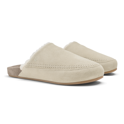 Pair of cream and taupe suede slip-on mules with stitched seams and cushioned soles.