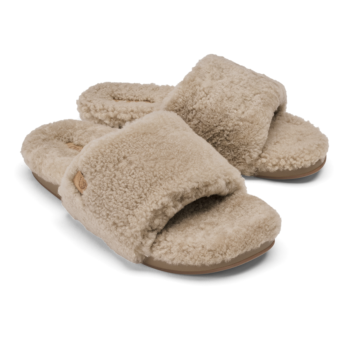 Pair of tan fleece slide slippers with textured wool upper and tan sole.