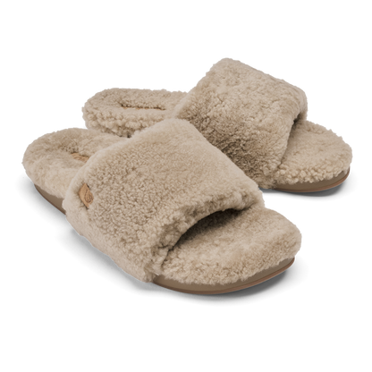 Pair of tan fleece slide slippers with textured wool upper and tan sole.