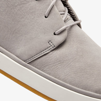 Graphite suede chukka boot with lace-up closure, cream sole, and tan crepe outsole.
